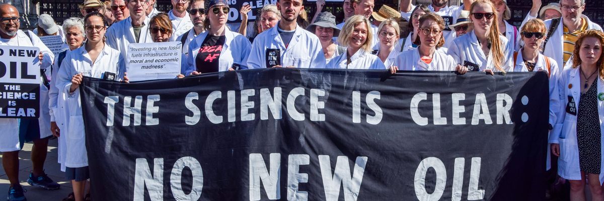 Scientists hold signs against new oil and gas