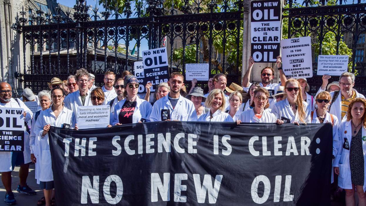 Scientists hold signs against new oil and gas