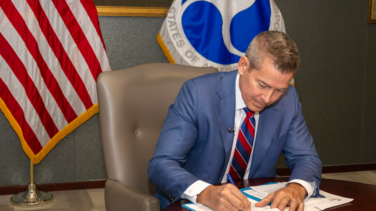 Sean Duffy signs a document