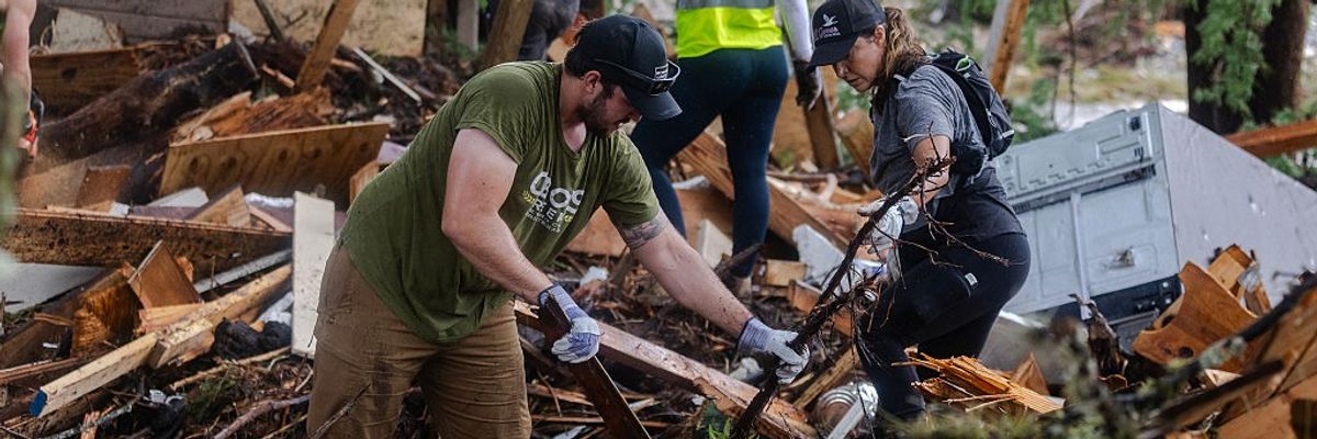 search and rescue workers dig through debris of Texas floods