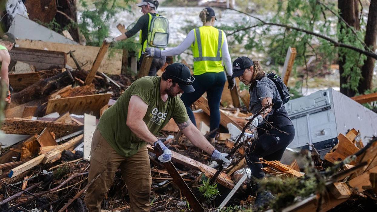 search and rescue workers dig through debris of Texas floods