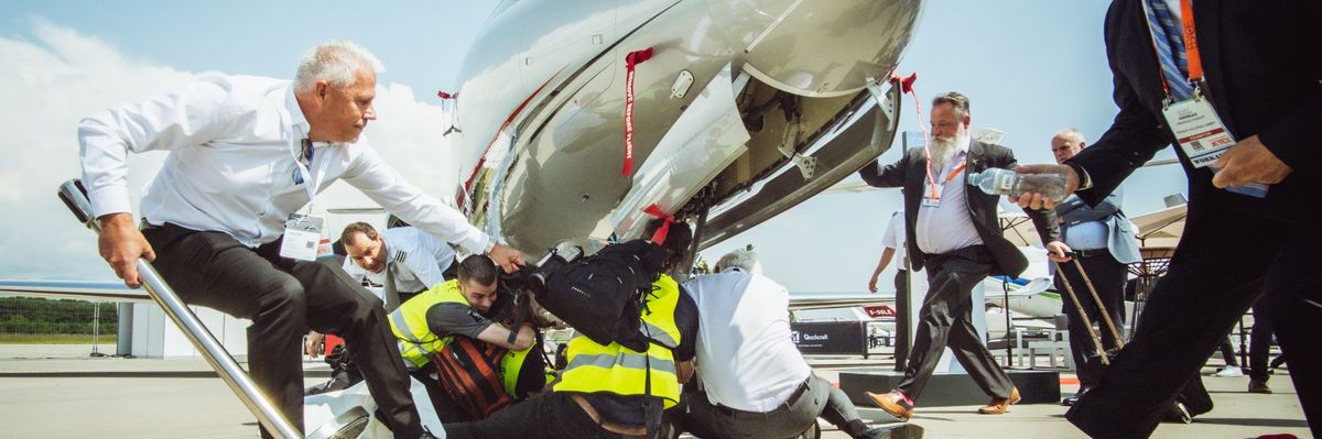 Security attempts to remove climate protesters blocking private jets at Geneva Airport