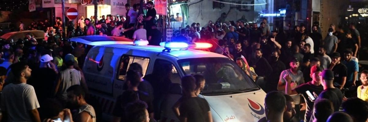 Security forces and healthcare teams arrive at the site of an explosion caused by an Israeli airstrike