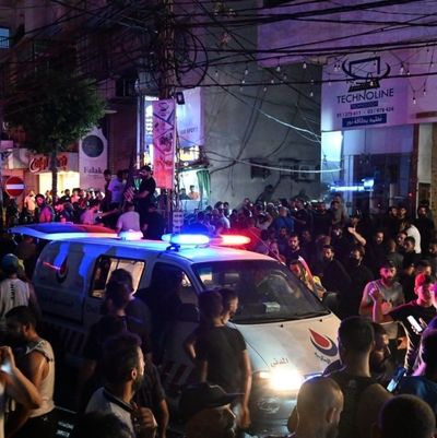 Security forces and healthcare teams arrive at the site of an explosion caused by an Israeli airstrike