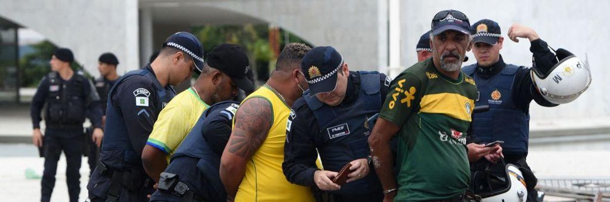 Security forces arrest supporters of Brazilian former President Jair Bolsonaro after retaking control of the presidential palace in Brasília, Brazil on January 8, 2023.