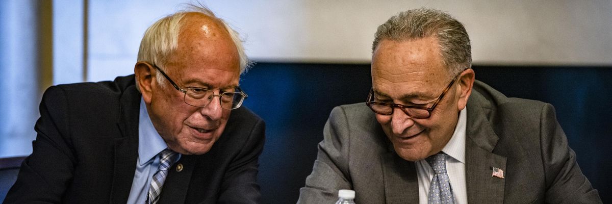 Sen. Bernie Sanders and Senate Majority Leader Chuck Schumer speak during a meeting