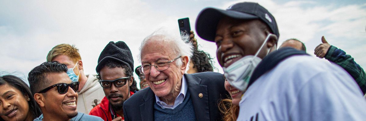 Sen. Bernie Sanders (I-Vt.) walks with Amazon workers during a rally outside one of the company's buildings in New York City on April 24, 2022.