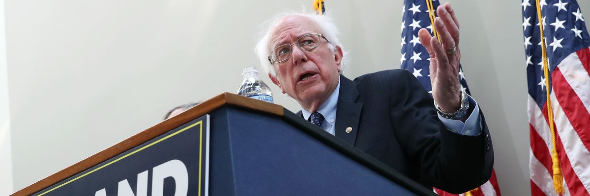 Sen. Bernie Sanders speaks at a podium with a sign reading, "Expand Social Security."