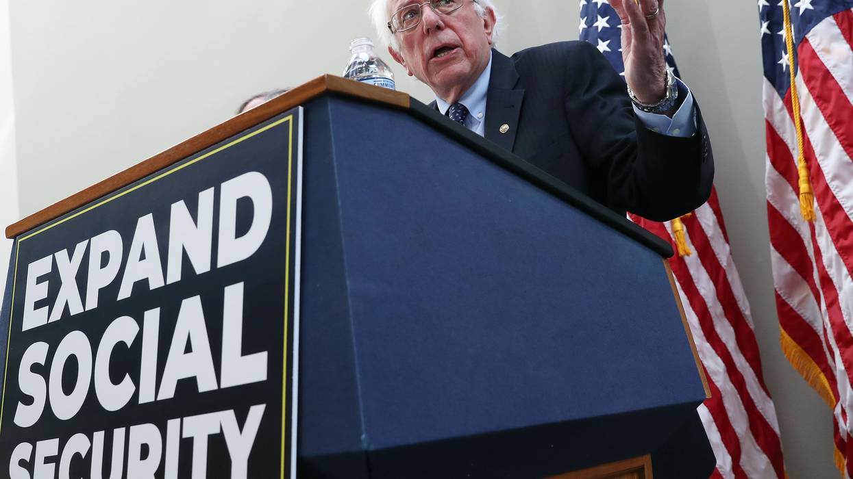 Sen. Bernie Sanders speaks at a podium with a sign reading, "Expand Social Security."