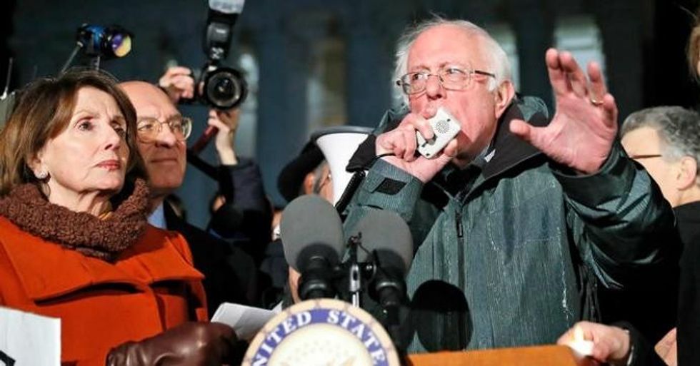 Sen. Bernie Sanders speaks with House Minority Leader Nancy Pelosi of Calif., left, and other members of Congress, in front of the Supreme Court about President Donald Trump's executive orders on immigration on January 30, 2017. (Photo: Alex Brandon / AP)