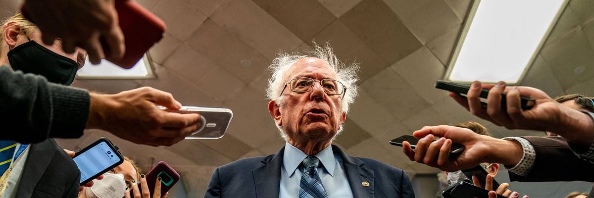 Sen. Bernie Sanders stands with reporters