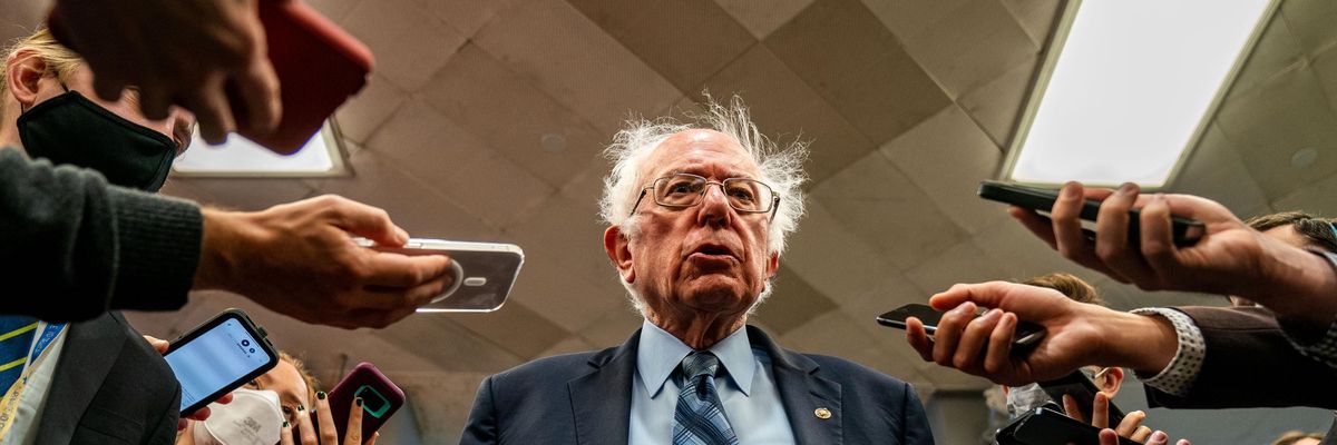 Sen. Bernie Sanders stands with reporters