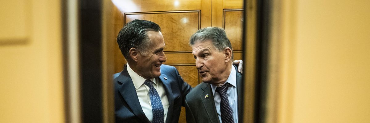 Sen. Joe Manchin (D-W.Va.) and Sen. Mitt Romney (R-Utah) chat in an elevator