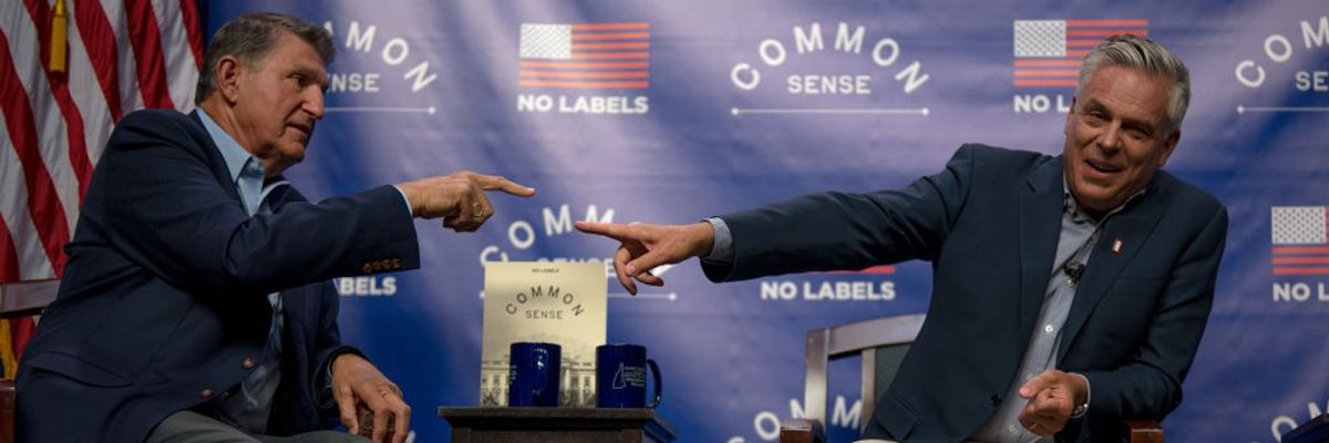 Sen. Joe Manchin III (D-W.Va.) and former Utah governor Jon Huntsman (R) point at each other.