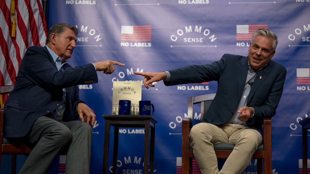 Sen. Joe Manchin III (D-W.Va.) and former Utah governor Jon Huntsman (R) point at each other.