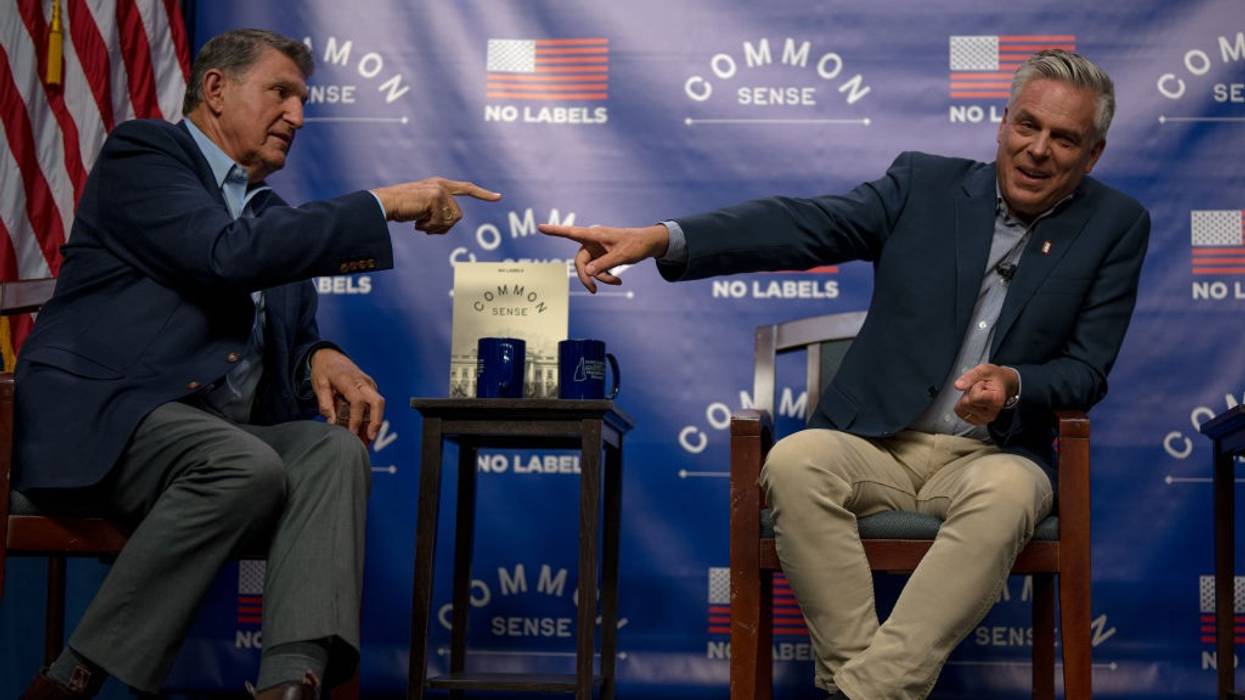 Sen. Joe Manchin III (D-W.Va.) and former Utah governor Jon Huntsman (R) point at each other.
