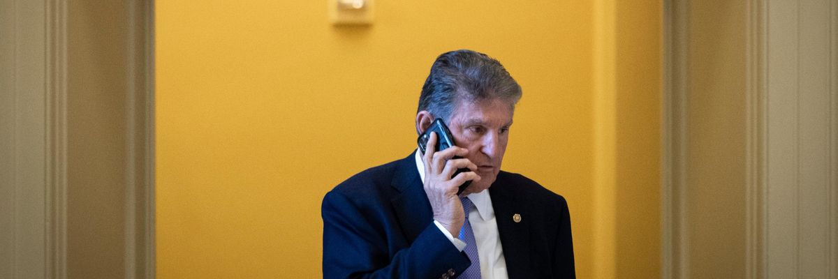 Sen. Joe Manchin speaks on the phone on Capitol Hill