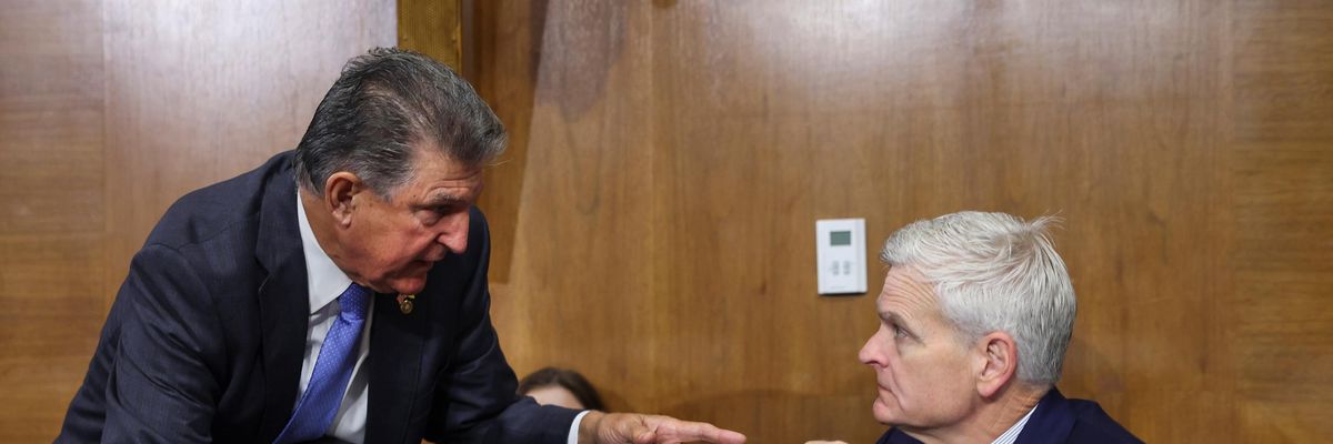 Sen. Joe Manchin speaks to Sen. Bill Cassidy in the Senate building