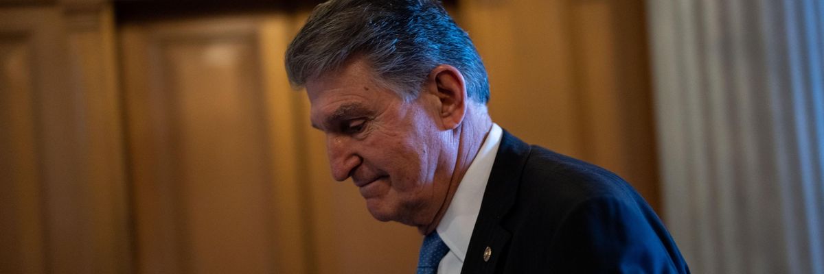 Sen. Joe Manchin walks in the Capitol hallway