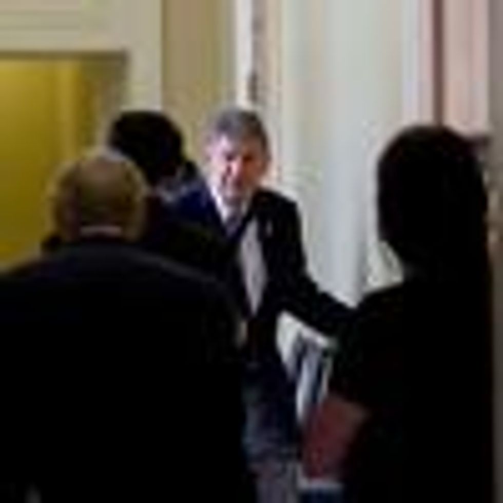 Sen. Joe Manchin walks to a policy lunch
