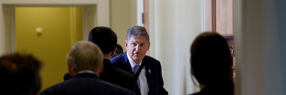 Sen. Joe Manchin walks to a policy lunch