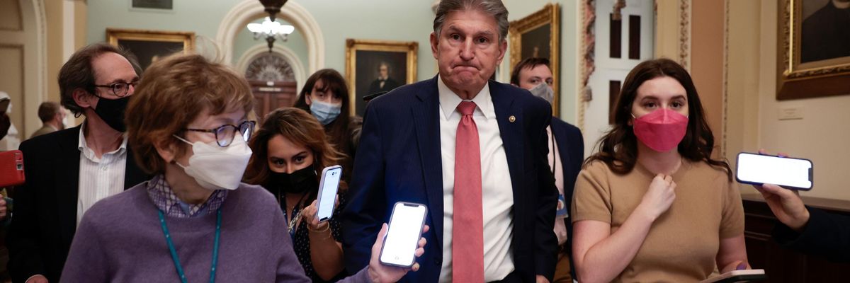 Sen. Joe Manchin walks with reporters
