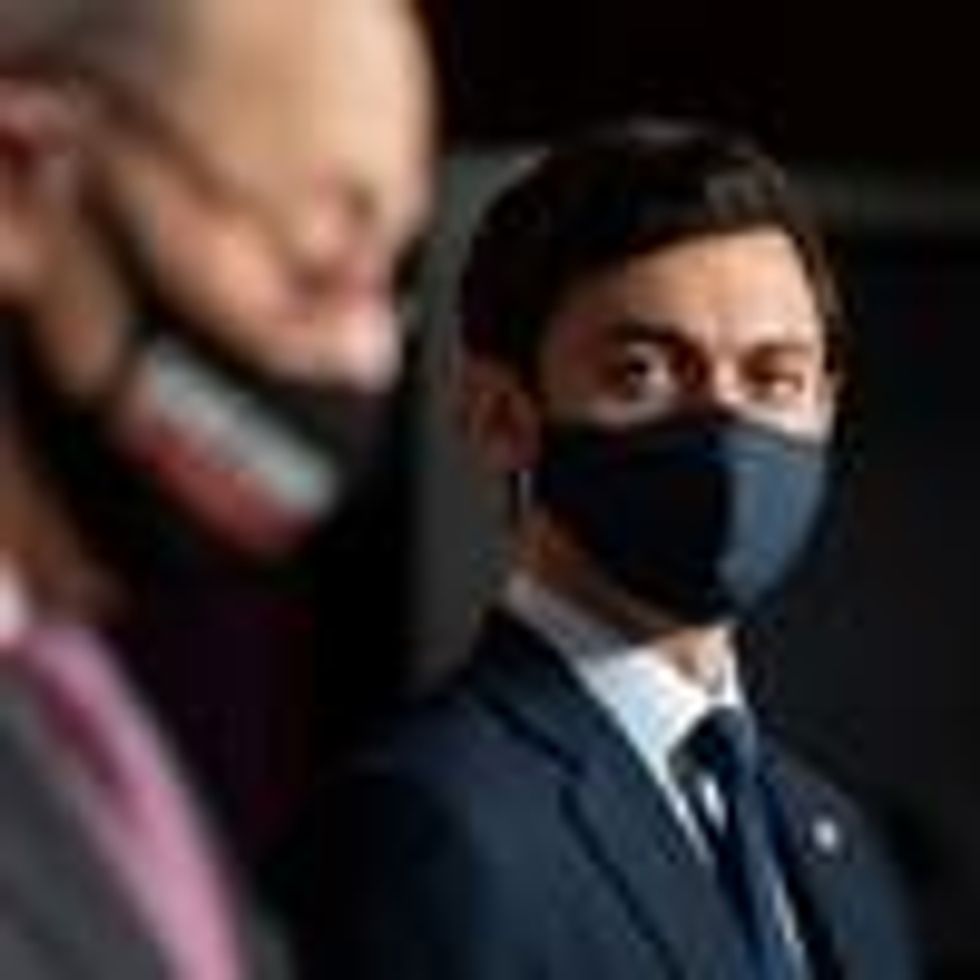 Sen. Jon Ossoff listens to Senate Majority Leader Chuck Schumer