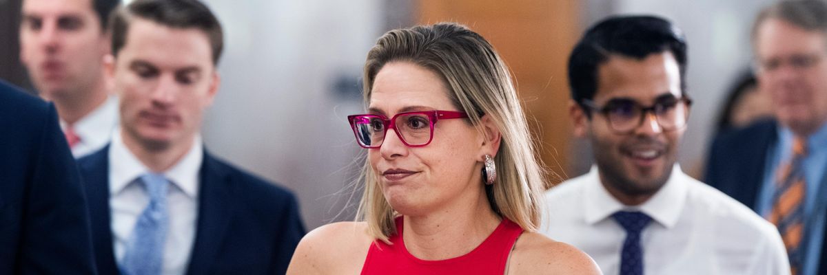 Sen. Kyrsten Sinema arrives for a hearing