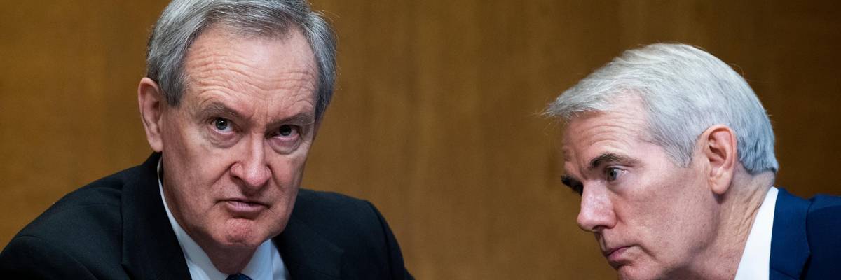 Sen. Mike Crapo speaks to Sen. Rob Portman