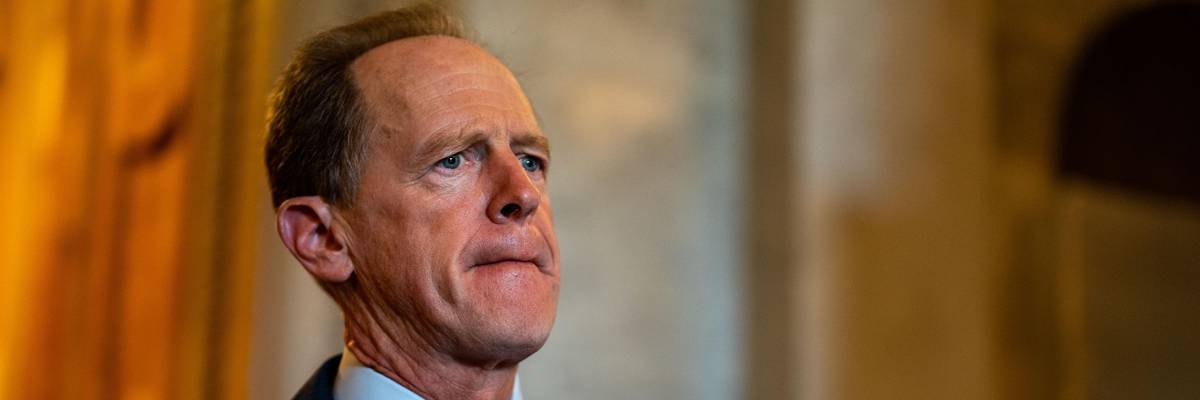 Sen. Pat Toomey walks in the Senate chamber