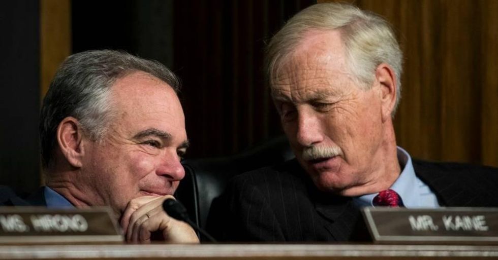 Sen. Tim Kaine (D-VA) talks with Sen. Angus King (I-ME) during a hearing on Capitol Hill, October 19, 2017 in Washington, DC. Both senators were among the seventeen Democratic caucus members who voted in favor of a financial dergulation bill on Tuesday.