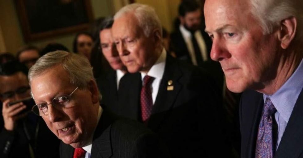 Senate Majority Leader Sen. Mitch McConnell (R-Ky.) speaks as Senate Majority Whip Sen. John Cornyn (R-Texas) and Sen. Orrin Hatch (R-Utah) listen during a news briefing after a weekly Senate Republican Policy Luncheon at the Capitol November 28, 2017 in Washington, D.C. (Photo: Alex Wong/Getty Images)