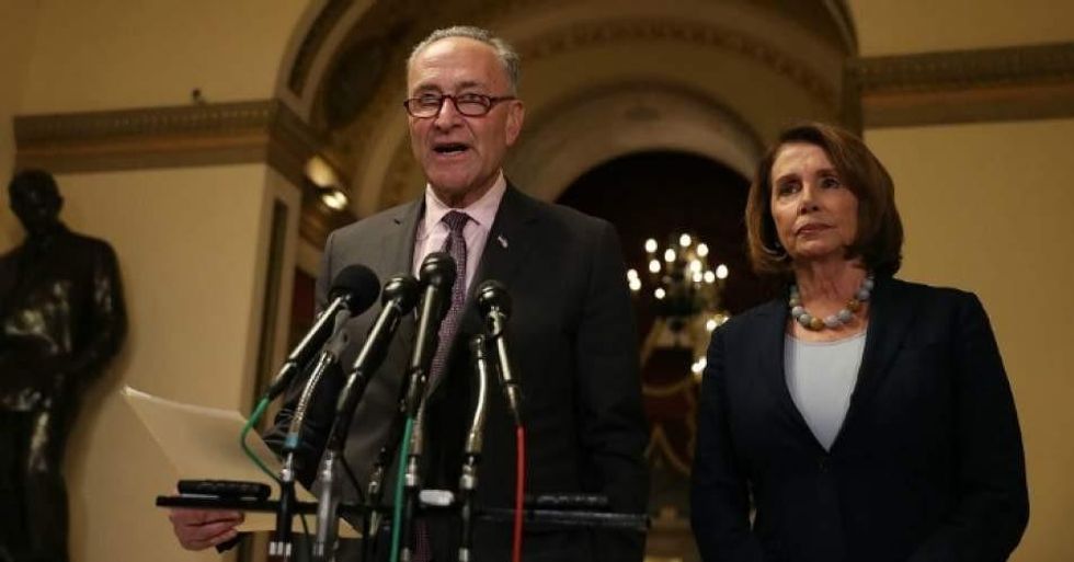 Senate Minority Leader Chuck Schumer (D-N.Y.) speaks as House Minority Leader Nancy Pelosi (D-Calif.) looks on during a news conference in Washington, D.C. (Photo by Justin Sullivan/Getty Images)