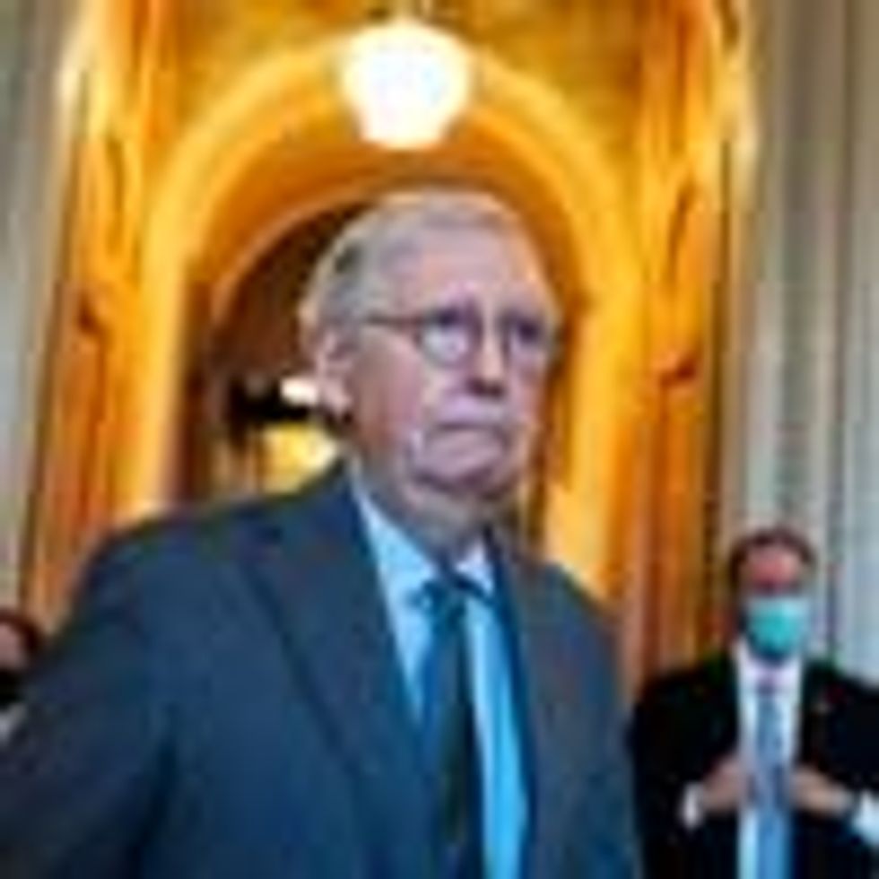 Senate Minority Leader Mitch McConnell walks through the halls of the Senate