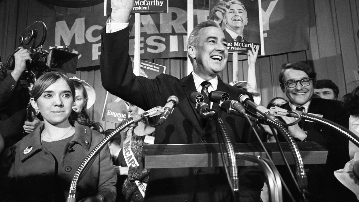 Senator Eugene McCarthy gives a "V" for victory sign