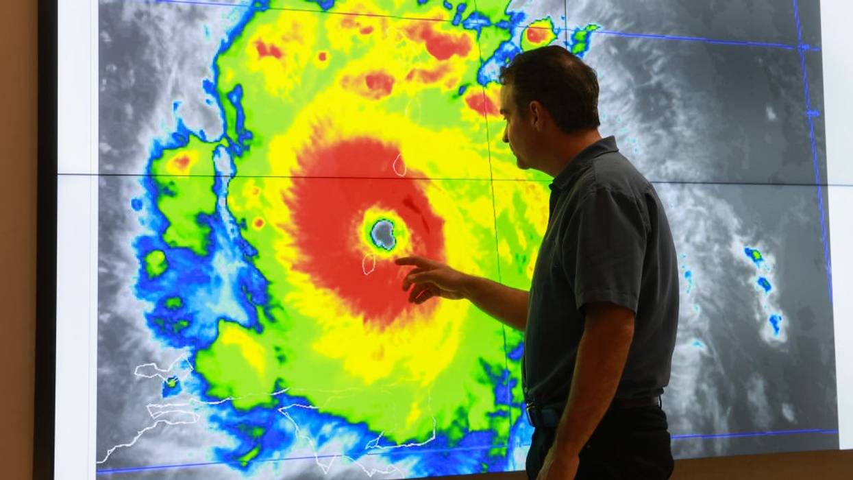 senior hurricane specialist at the National Hurricane Center inspects a satellite image of Hurricane Beryl