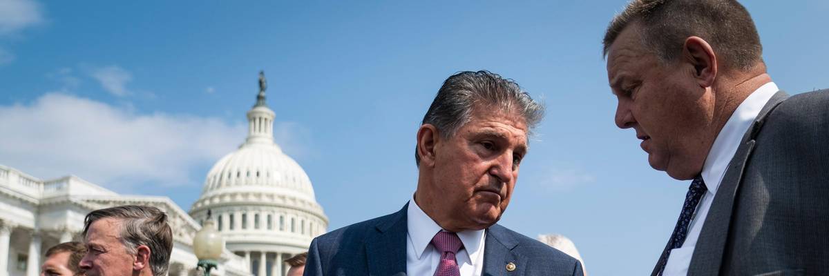 Sens. Joe Manchin and Jon Tester speak during a press conference.