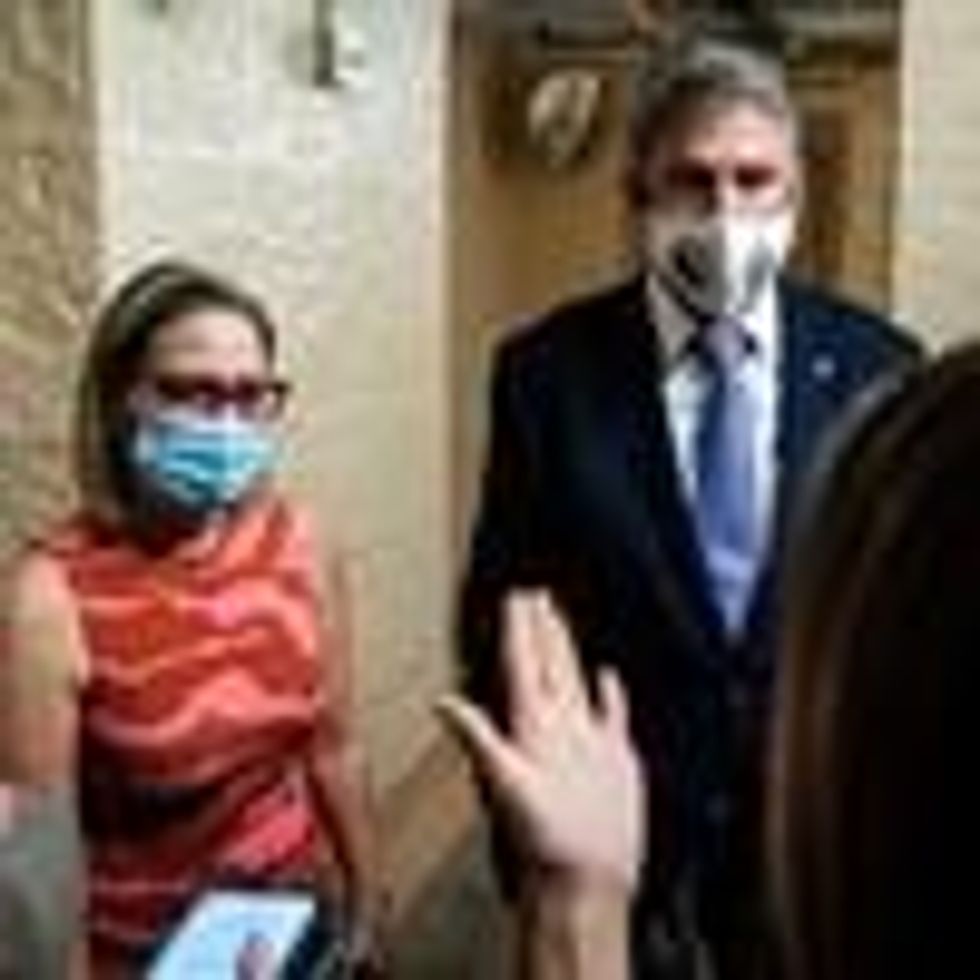 Sens. Kyrsten Sinema and Joe Manchin speak to reporters