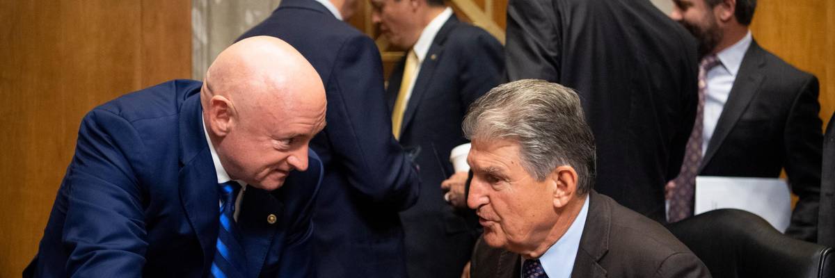 Sens. Mark Kelly and Joe Manchin speak at a hearing