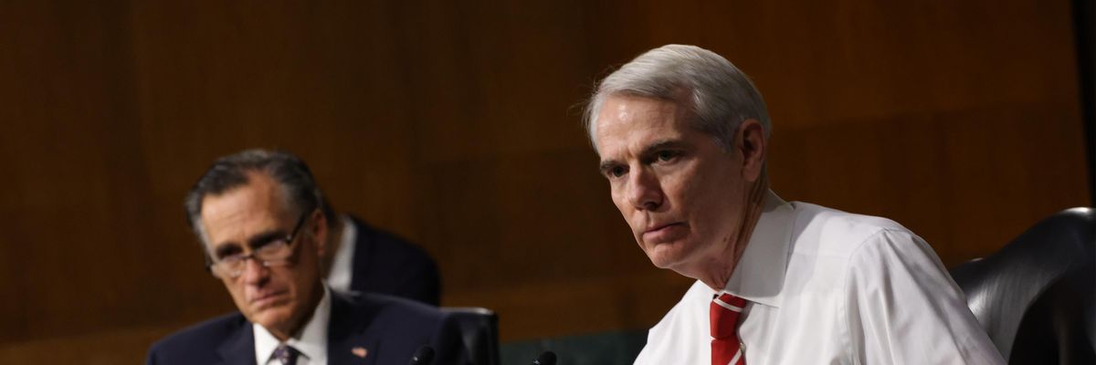 Sens. Rob Portman and Mitt Romney participate in a hearing