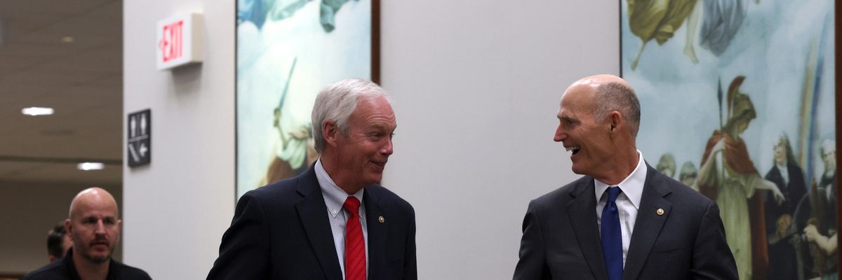 Sens. Ron Johnson and Rick Scott walk to a hearing