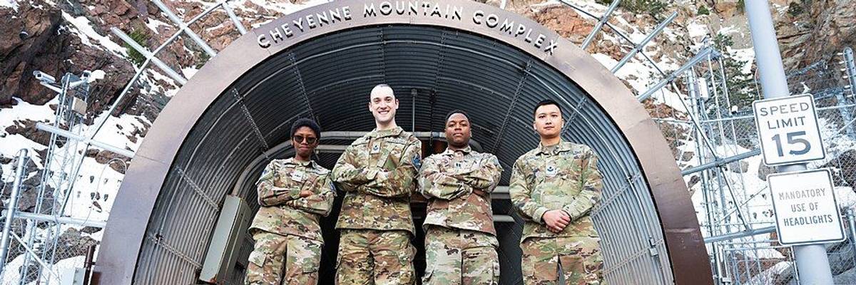 Service members in front of Cheyenne Mountain