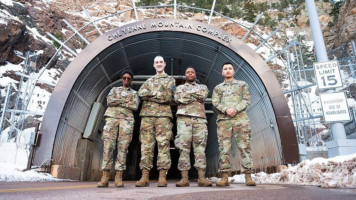 Service members in front of Cheyenne Mountain