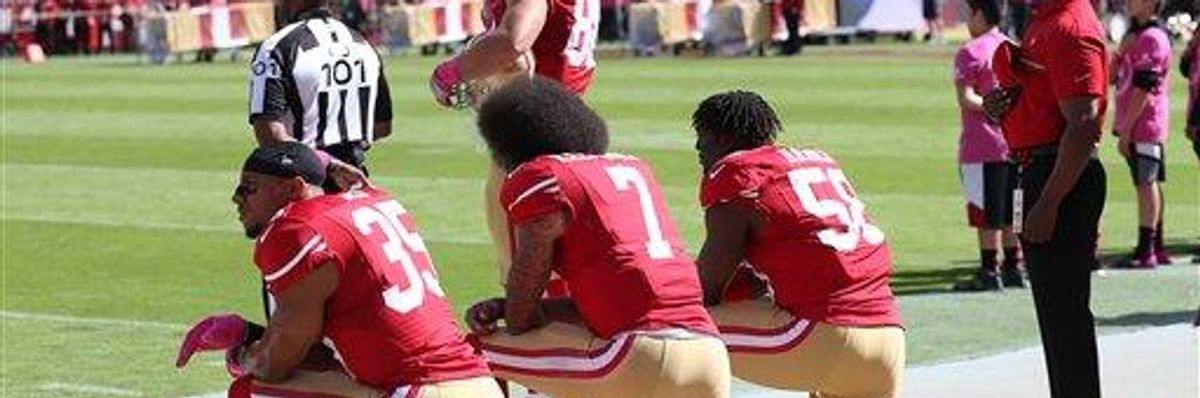 Several San Francisco 49ers including Colin Kaepernick, center, kneel during the National Anthem prior to an NFL football game in October, 2016