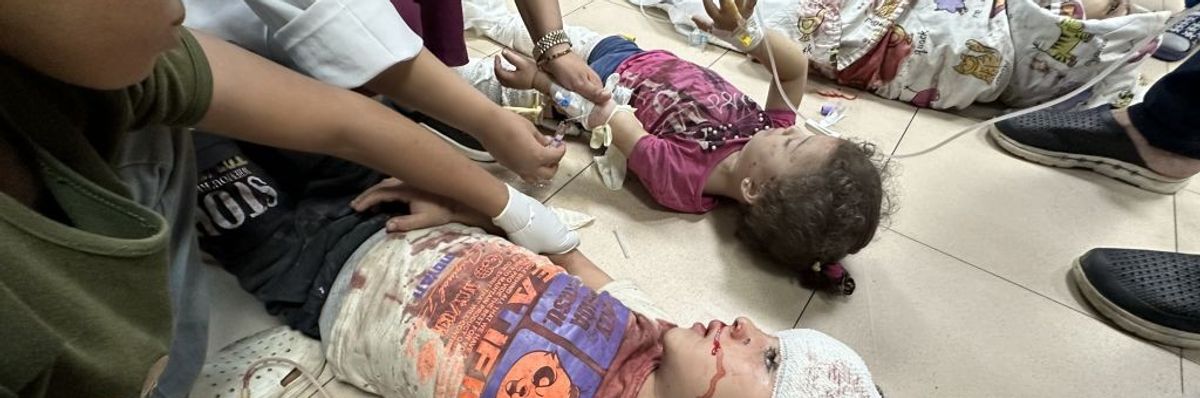 Severely injured Palestinian children lay on the floor in a Gaza hospital