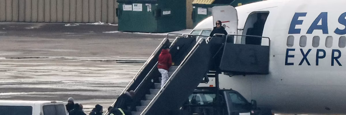 Shackled people board a deportation flight