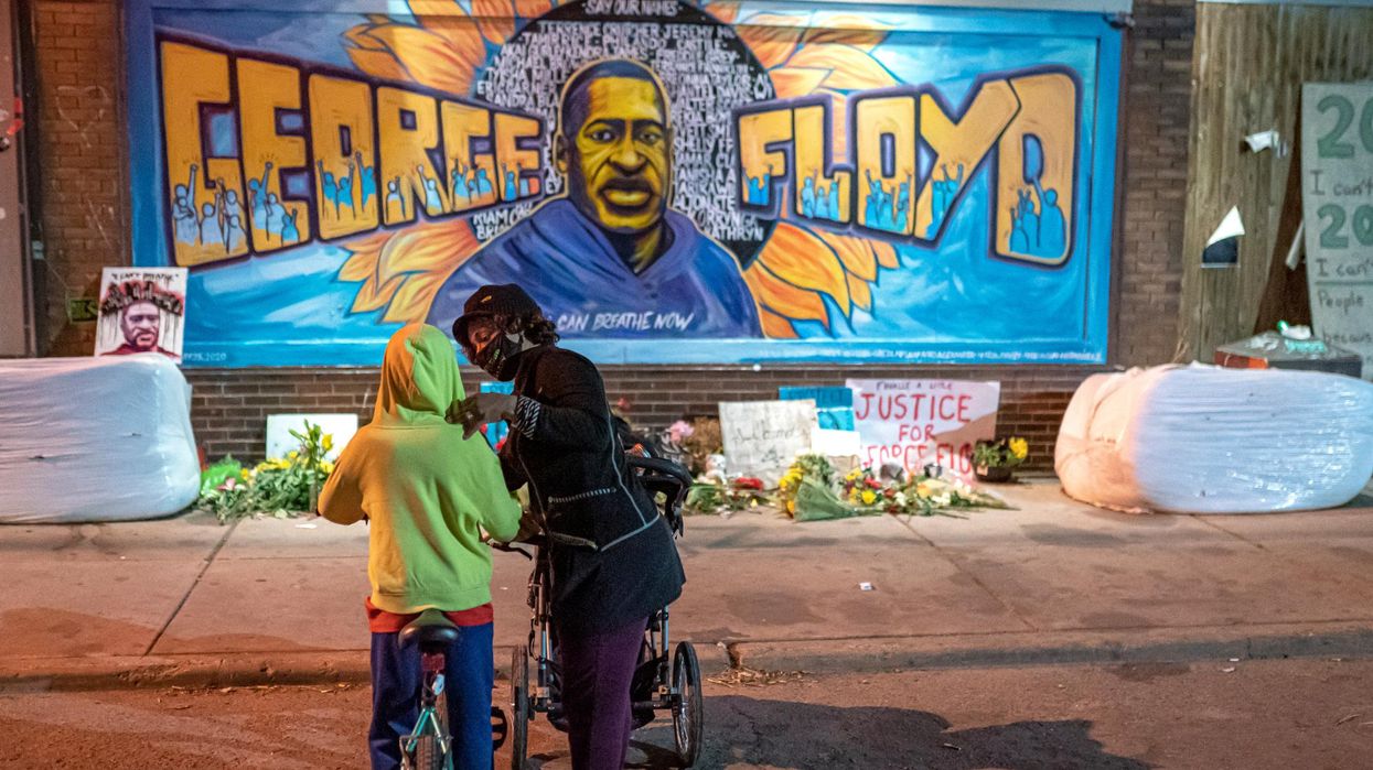 Shannon Haynes talks to her son Ronald Haynes, 9, about George Floyd in front of a memorial following the verdict in the trial of former police officer Derek Chauvin on April 20, 2021 in Minneapolis