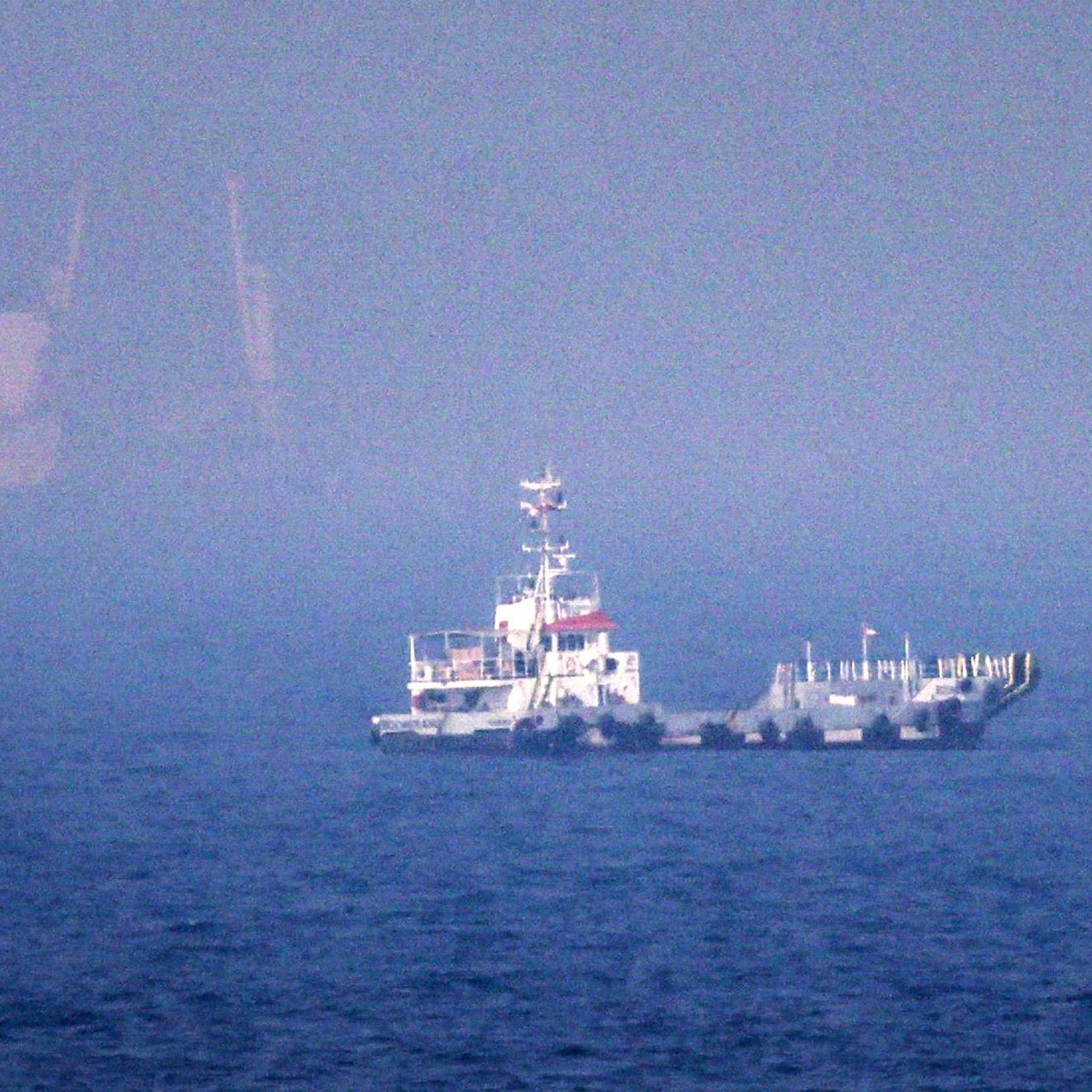 Ships sail near the Strait of Hormuz off the eastern coast of the United Arab Emirates