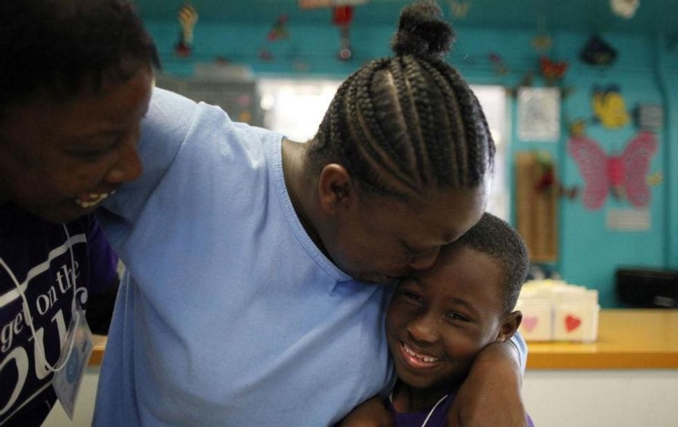 Shonta Montgomery hugs her son Levell Jones at California Institute for Women in Chino, California. (Reuters / Lucy Nicholson)