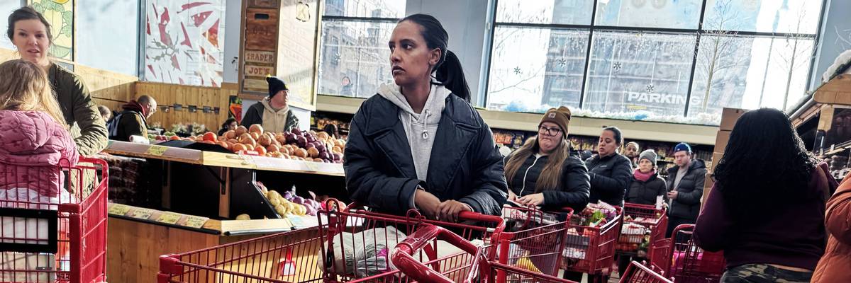 Shoppers wait in line at a grocery store in Washington, DC on January 23, 2026. 